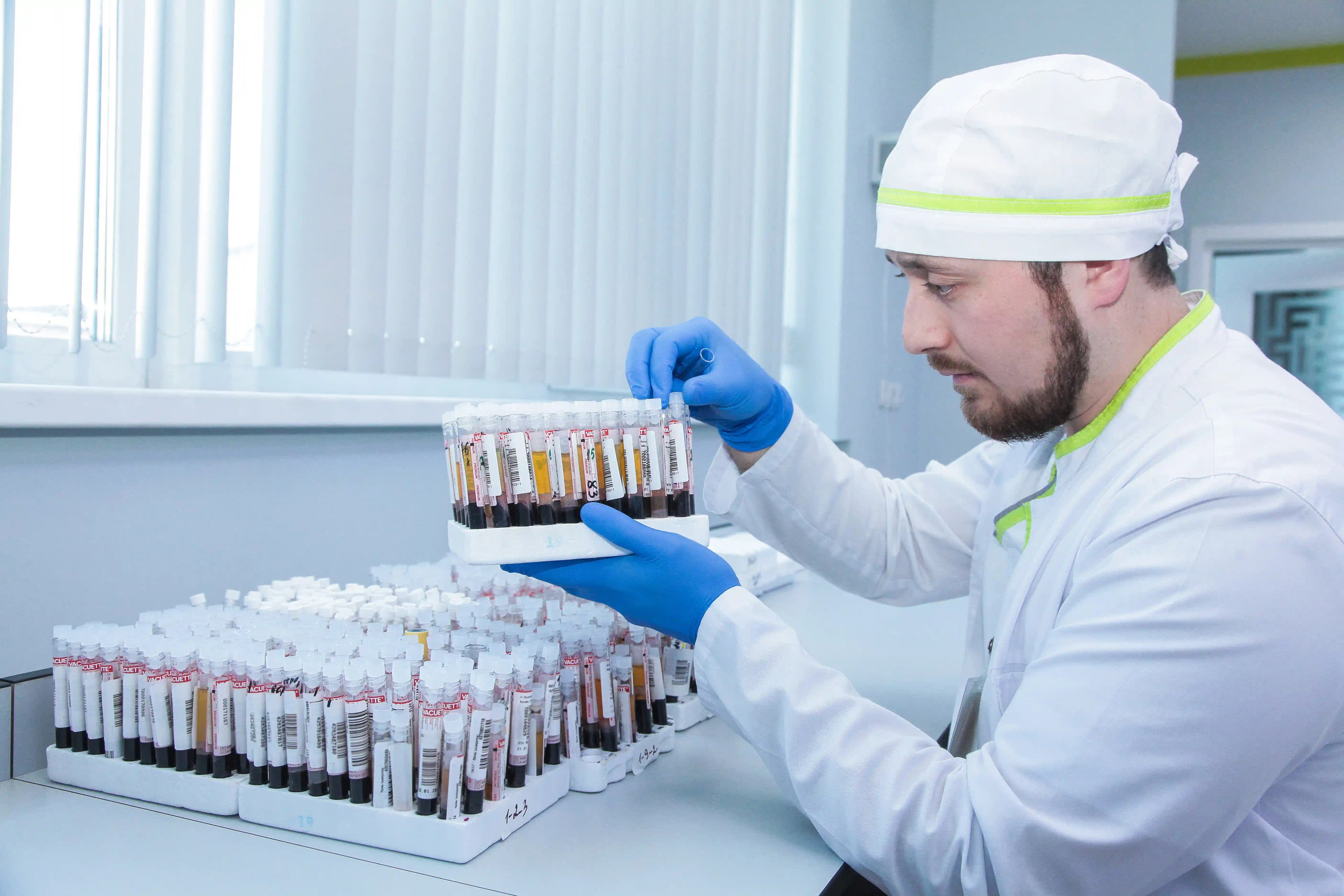 A Labquest specialist sorts tubes with blood samples
