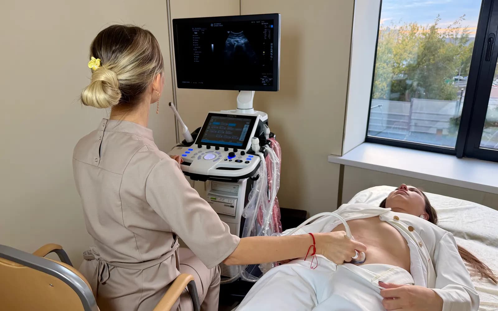 A specialist performing an abdominal ultrasound scan