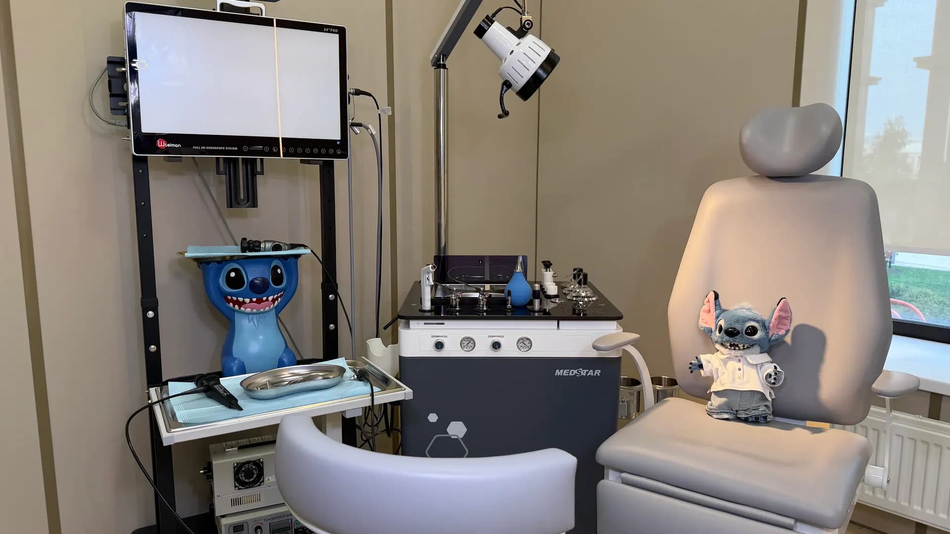 Pediatric ENT room with an endoscopy tower, an ENT unit and soft toys
