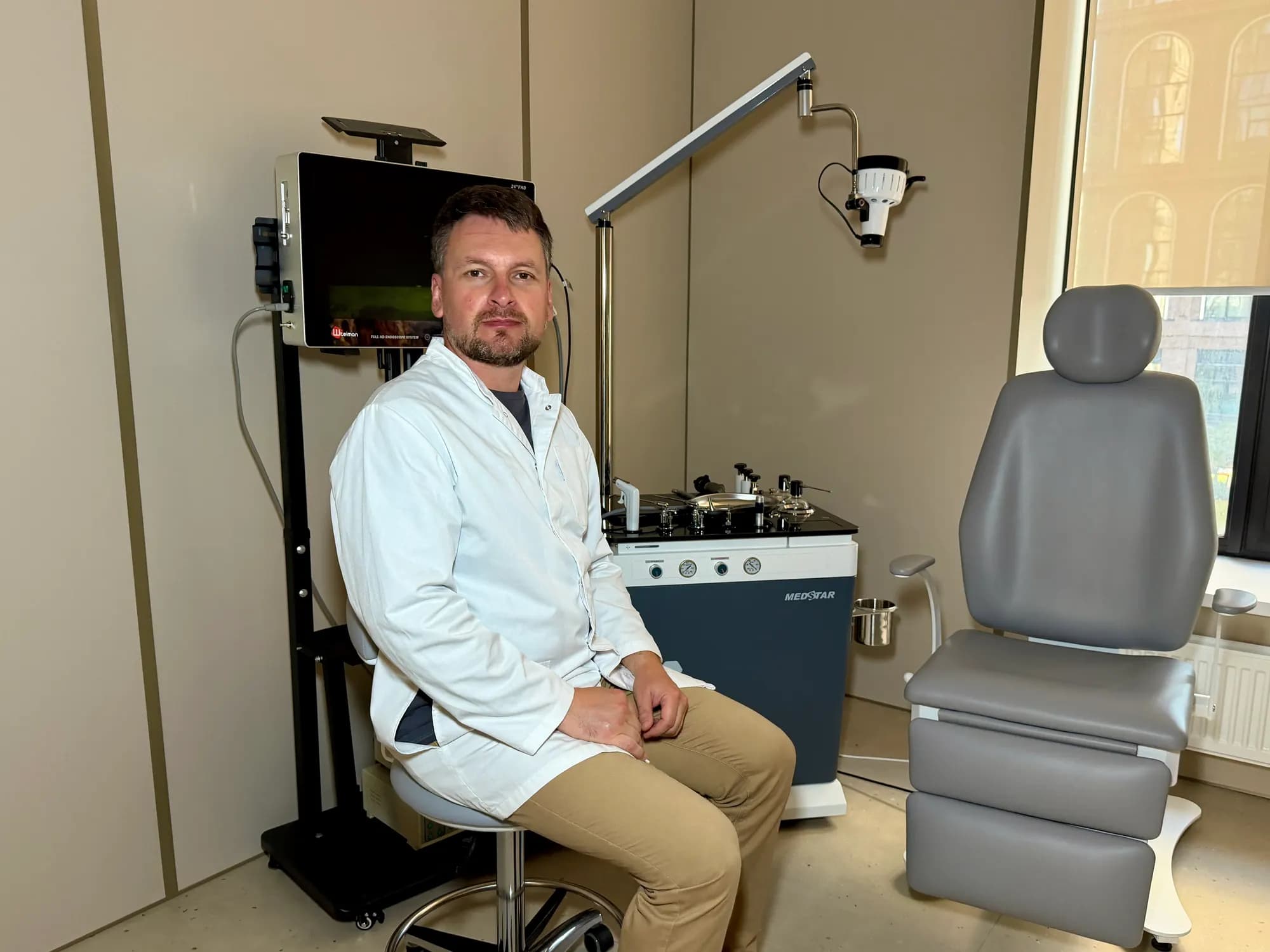 ENT room: a doctor at the ENT workstation next to the patient chair